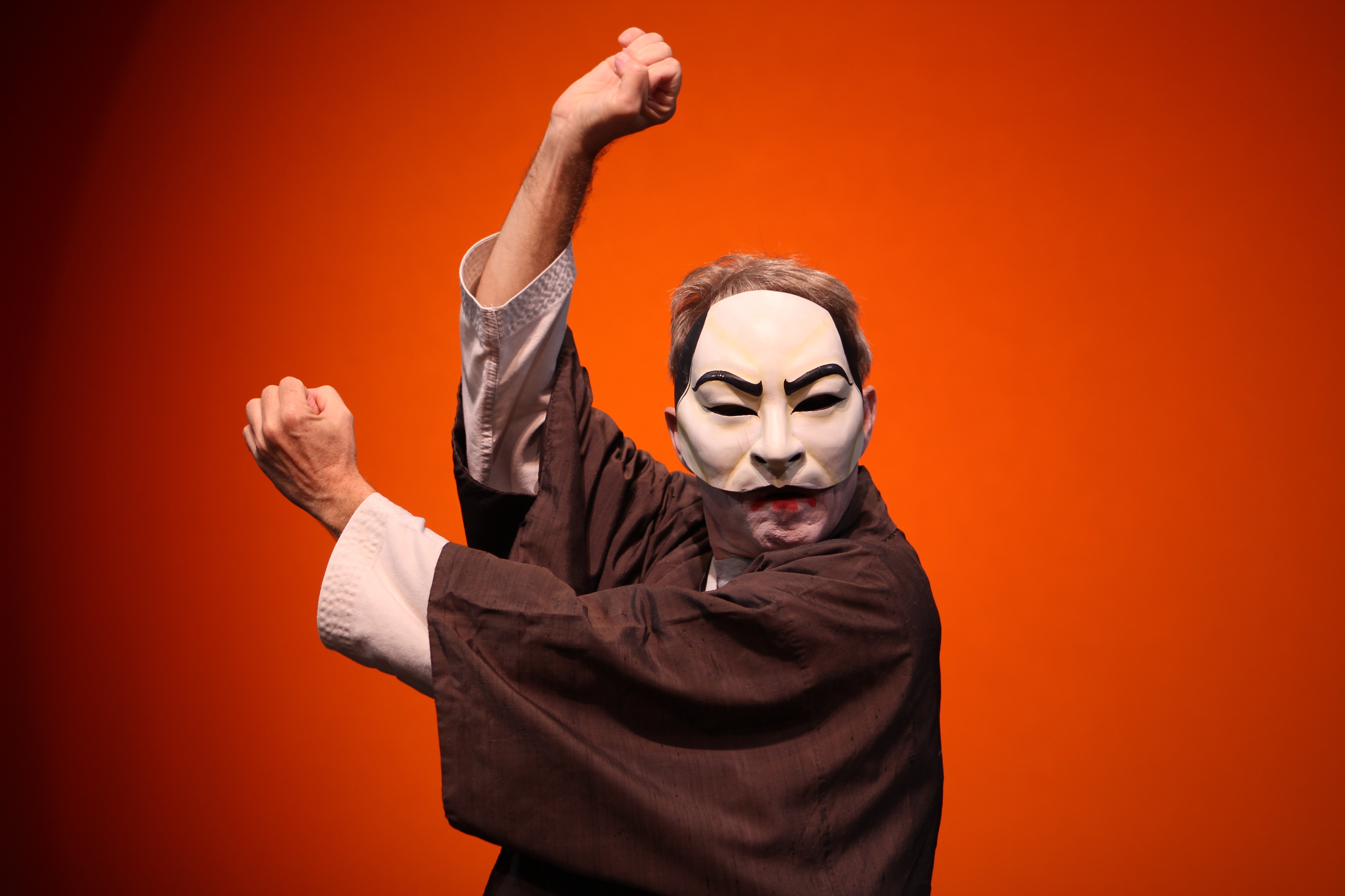 Samurai mask in nunchuck pose, orange packground